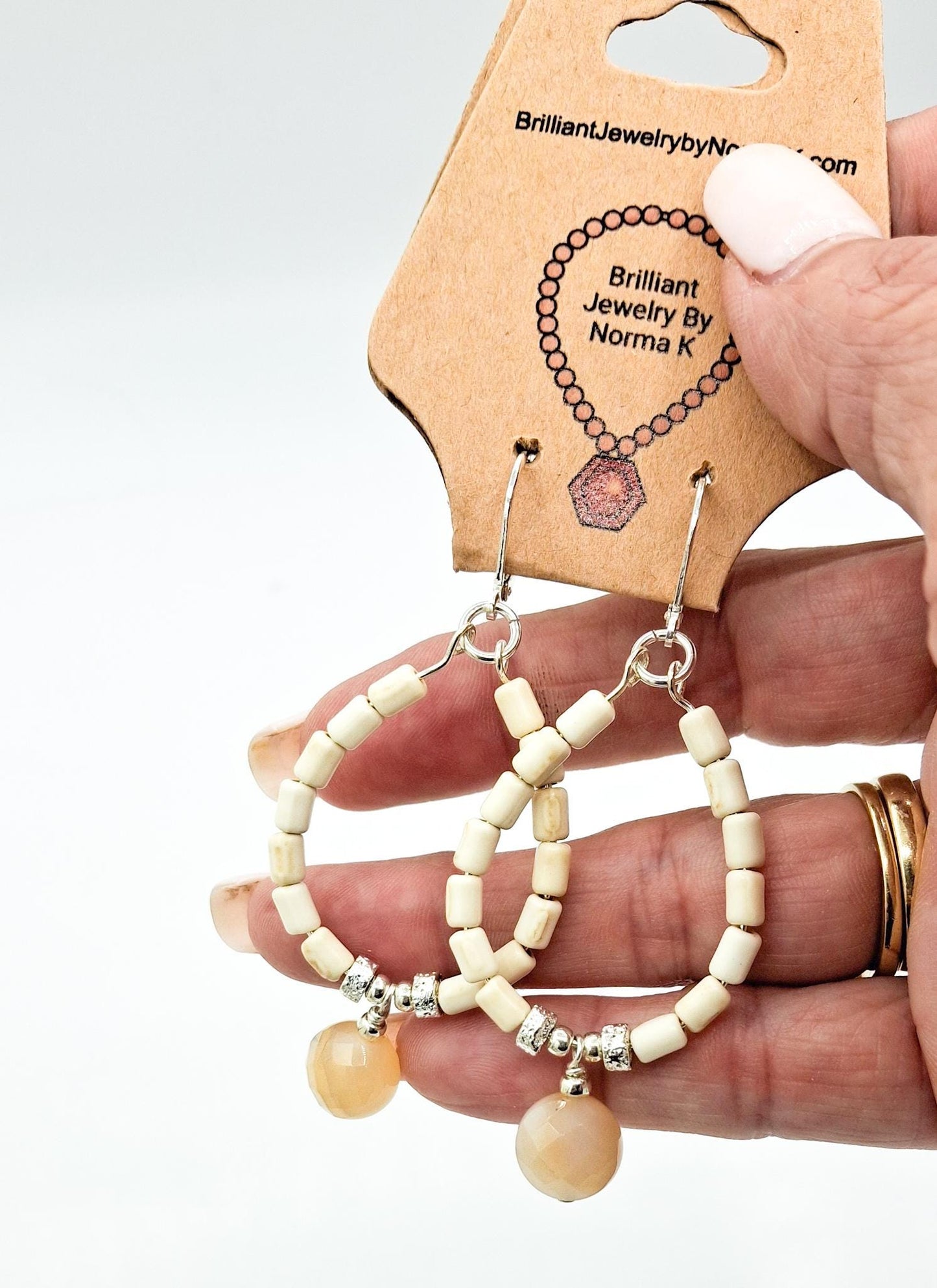 Nk Creme colored plated Hematite hoop earrings with a faceted Agate drop