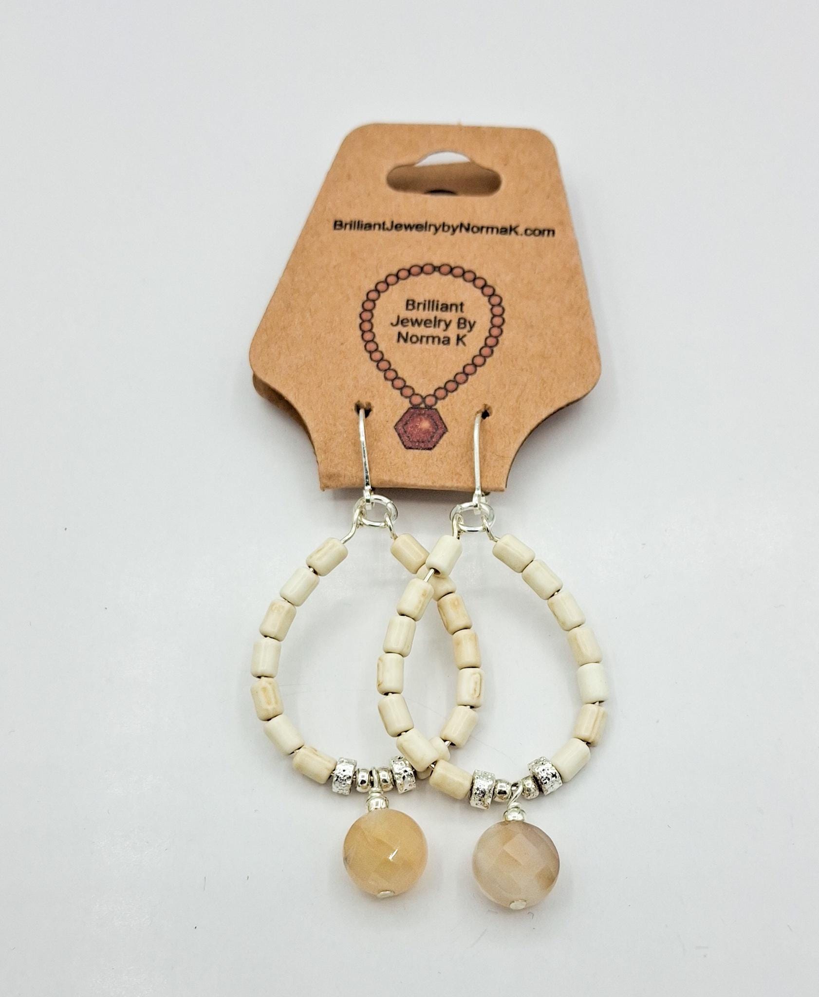 Nk Creme colored plated Hematite hoop earrings with a faceted Agate drop