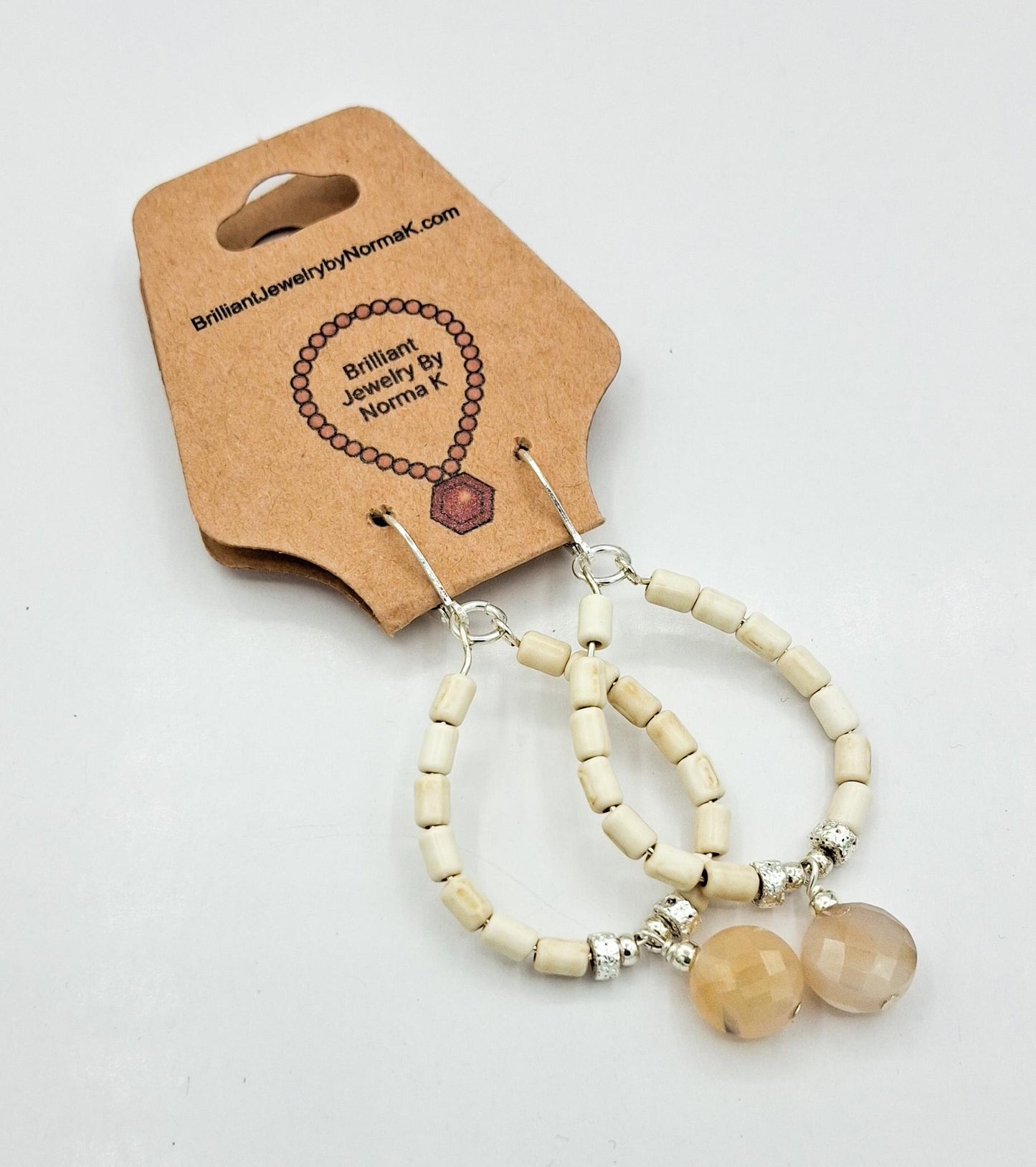 Nk Creme colored plated Hematite hoop earrings with a faceted Agate drop