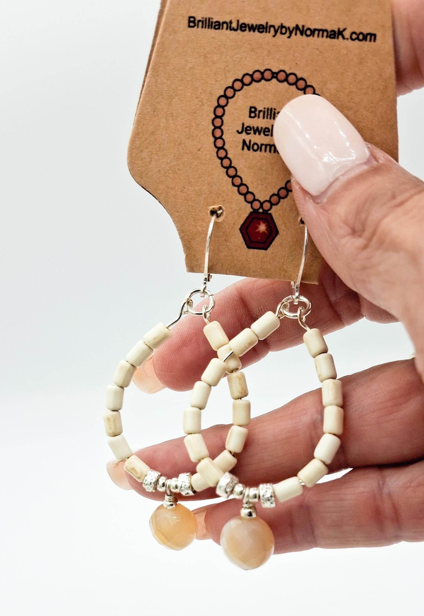 Nk Creme colored plated Hematite hoop earrings with a faceted Agate drop