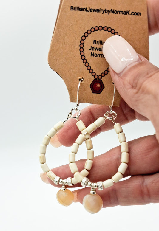 Nk Creme colored plated Hematite hoop earrings with a faceted Agate drop